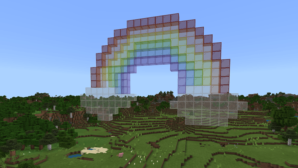 A giant rainbow built from colored glass blocks in Minecraft.